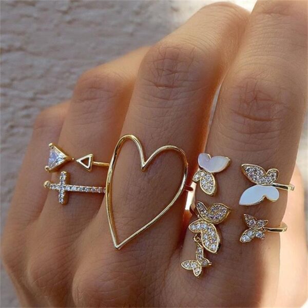 1838896310330200064 Gold Stackable Rings Set - Heart, Butterfly & Cross Designs