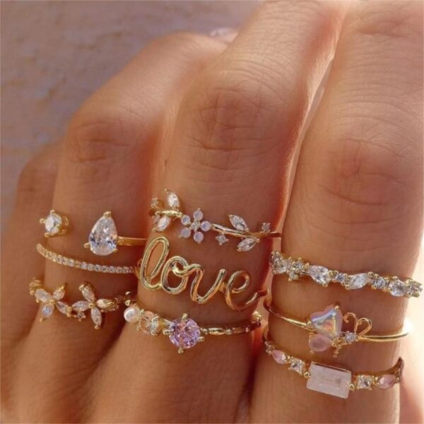 1923277235326947328 Gold Stackable Rings Set with Crystal & Love Script Design